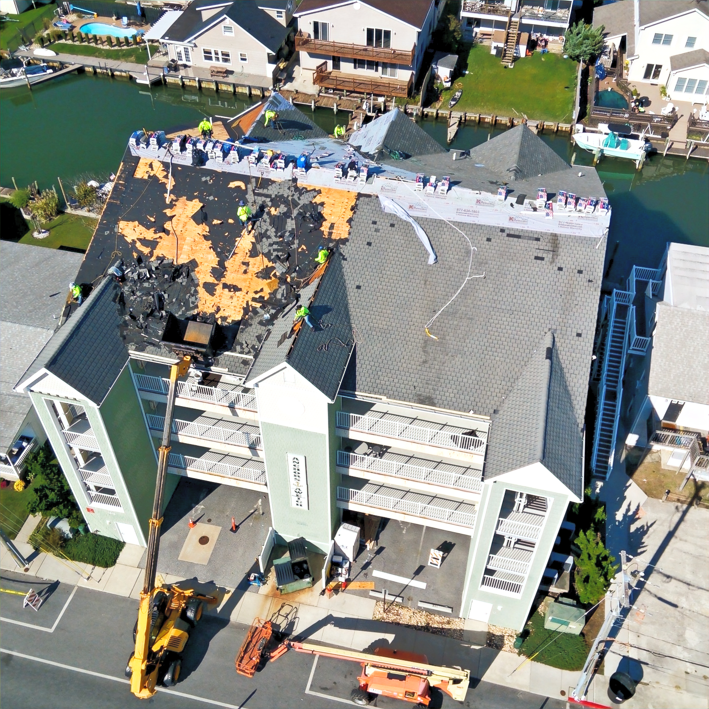 GMP roofing crew working on a waterfront residential roof